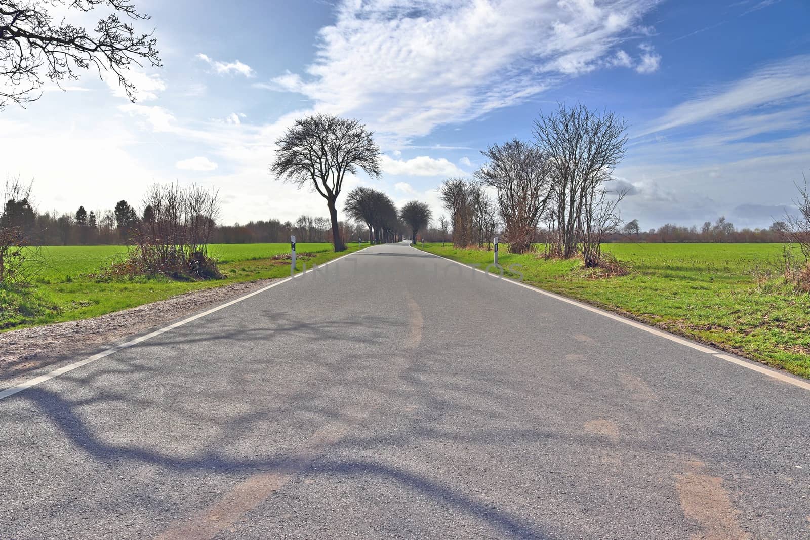 Beautiful view on countryside roads with fields and trees in northern europe.