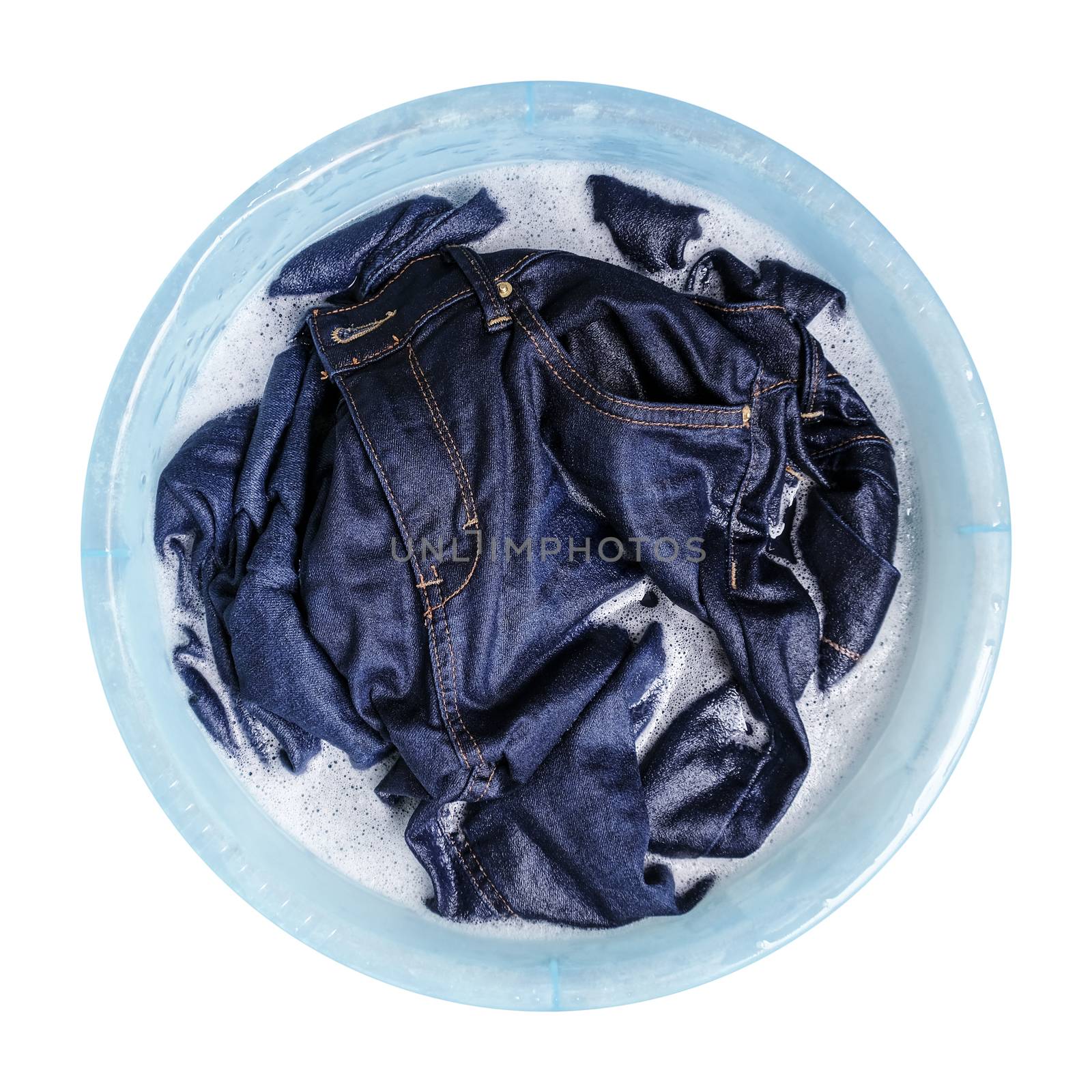Blue jeans with liquid detergent in the plastic basin isolated o by Myimagine