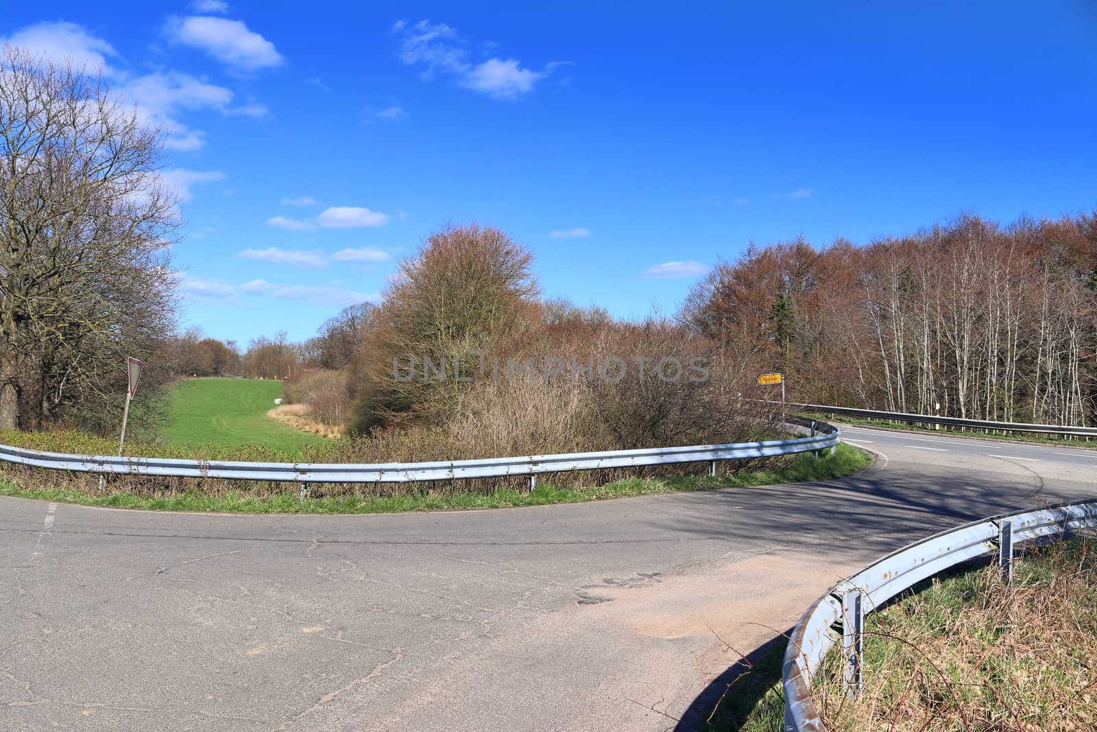 Beautiful view on countryside roads with fields and trees in northern europe.