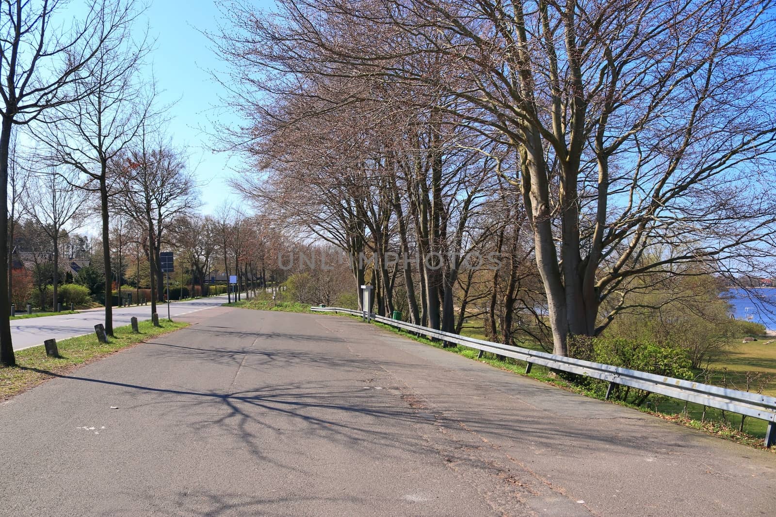 Beautiful view on countryside roads with fields and trees in northern europe.