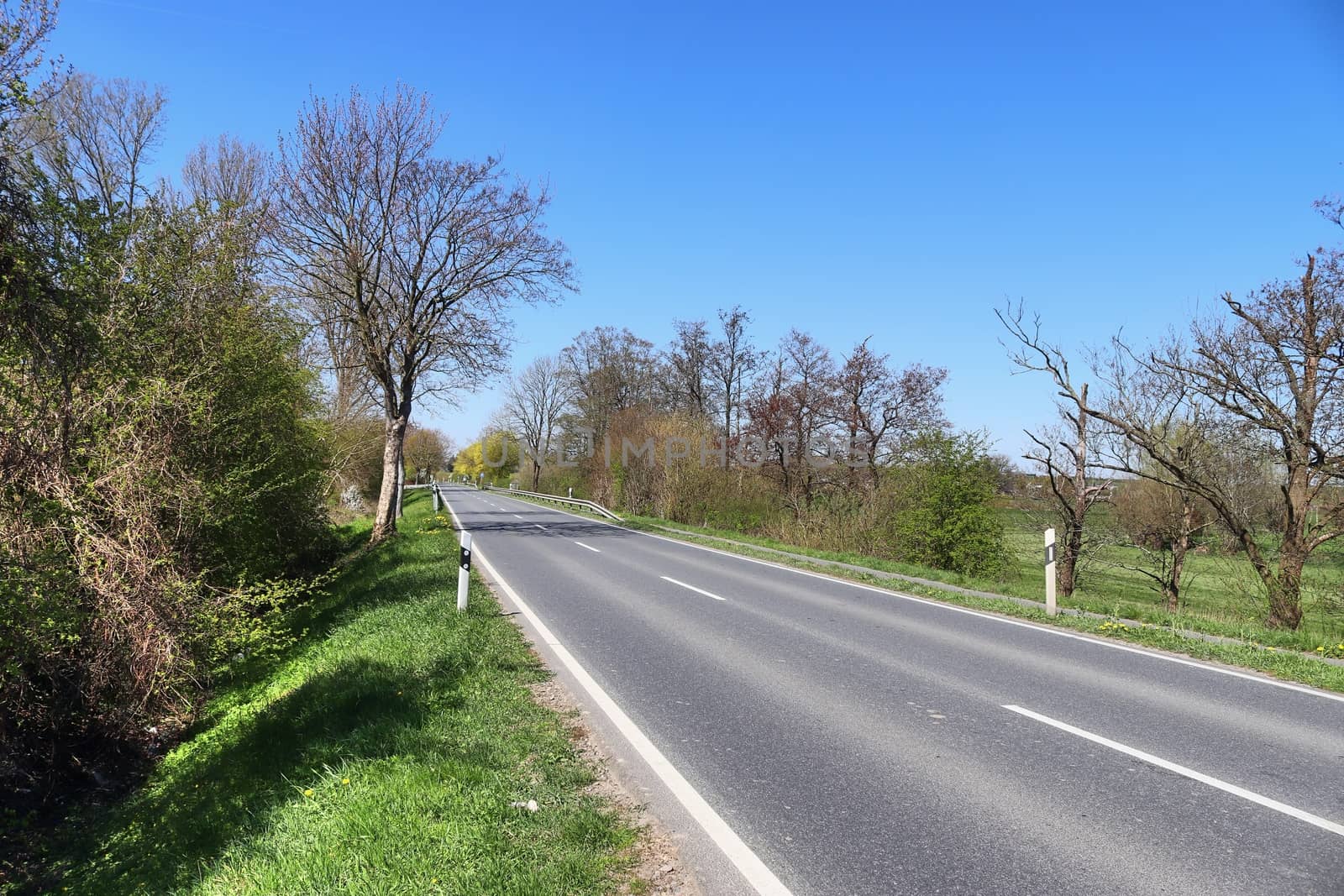 Beautiful view on countryside roads with fields and trees in northern europe.