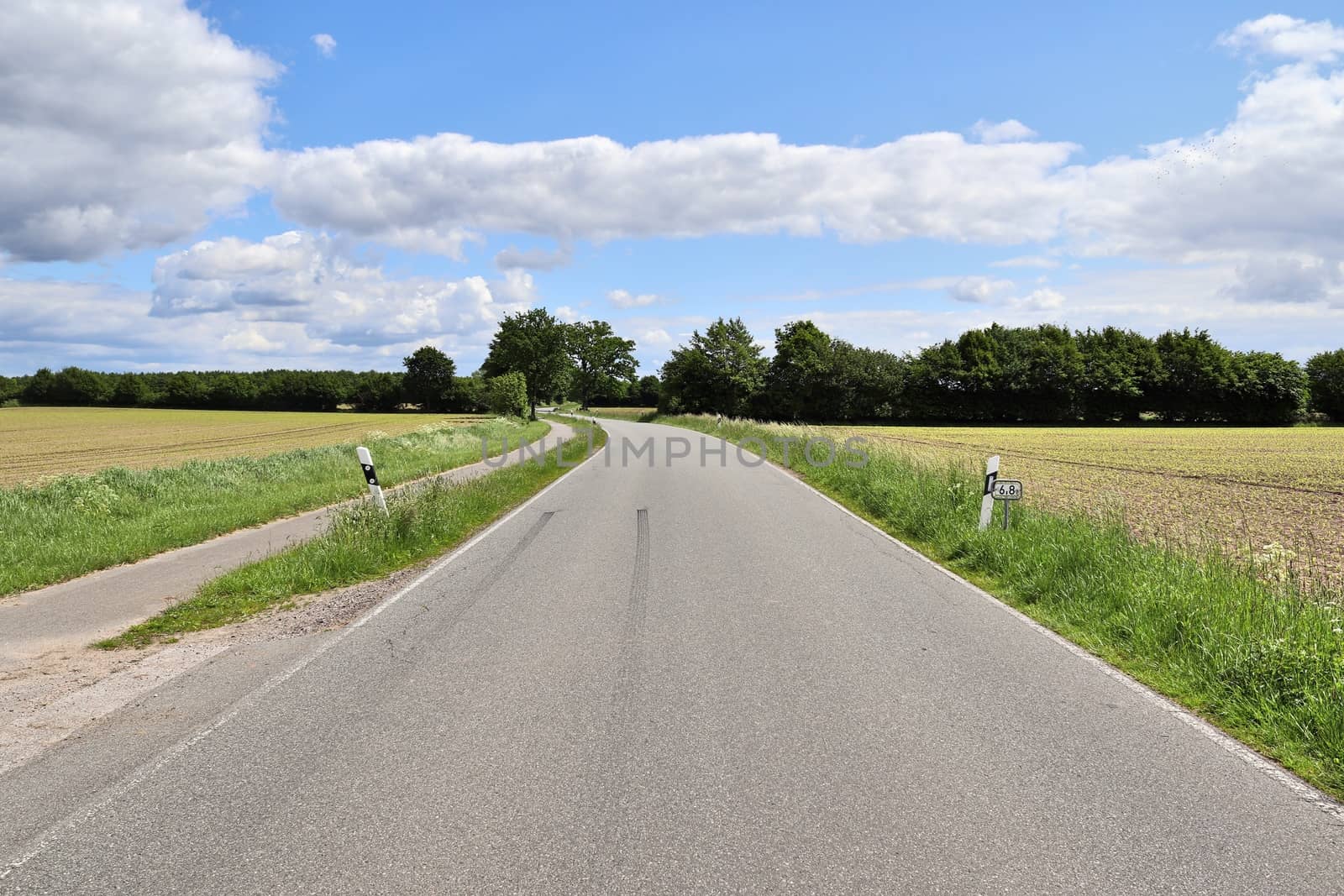 Beautiful view on countryside roads with fields and trees in northern europe.