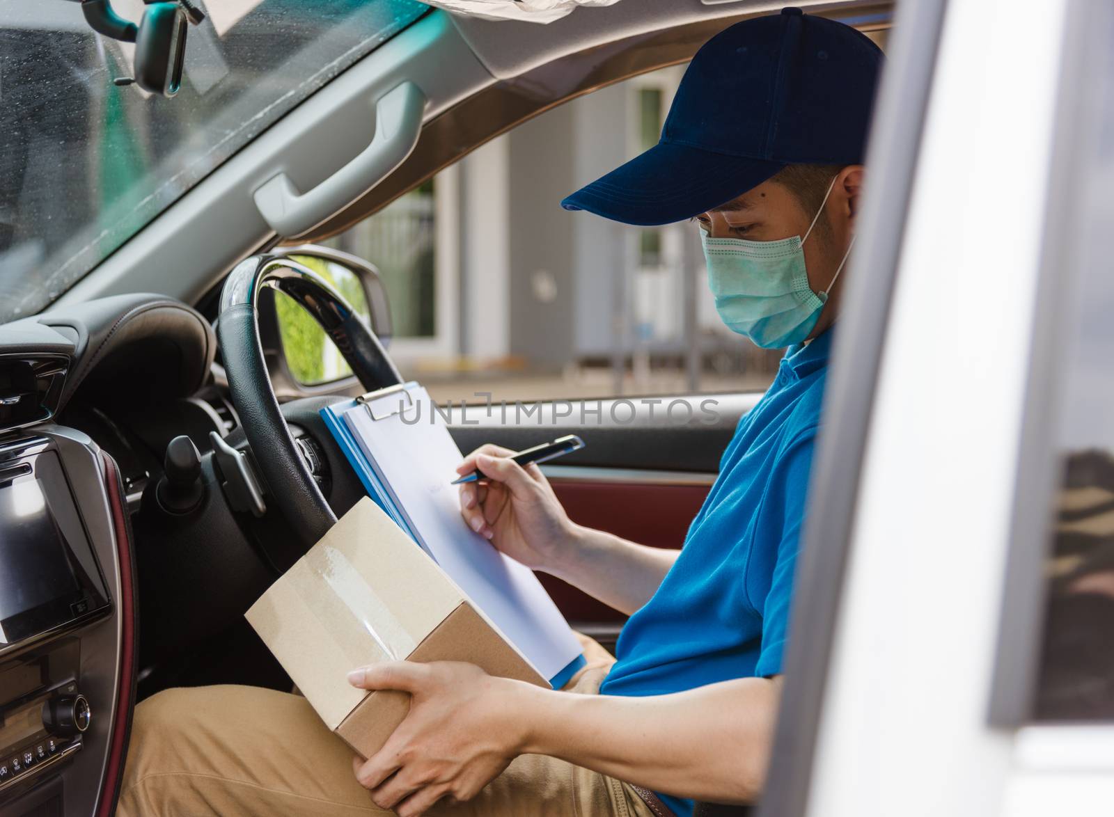 delivery courier young man driver inside the van car with parcel by Sorapop