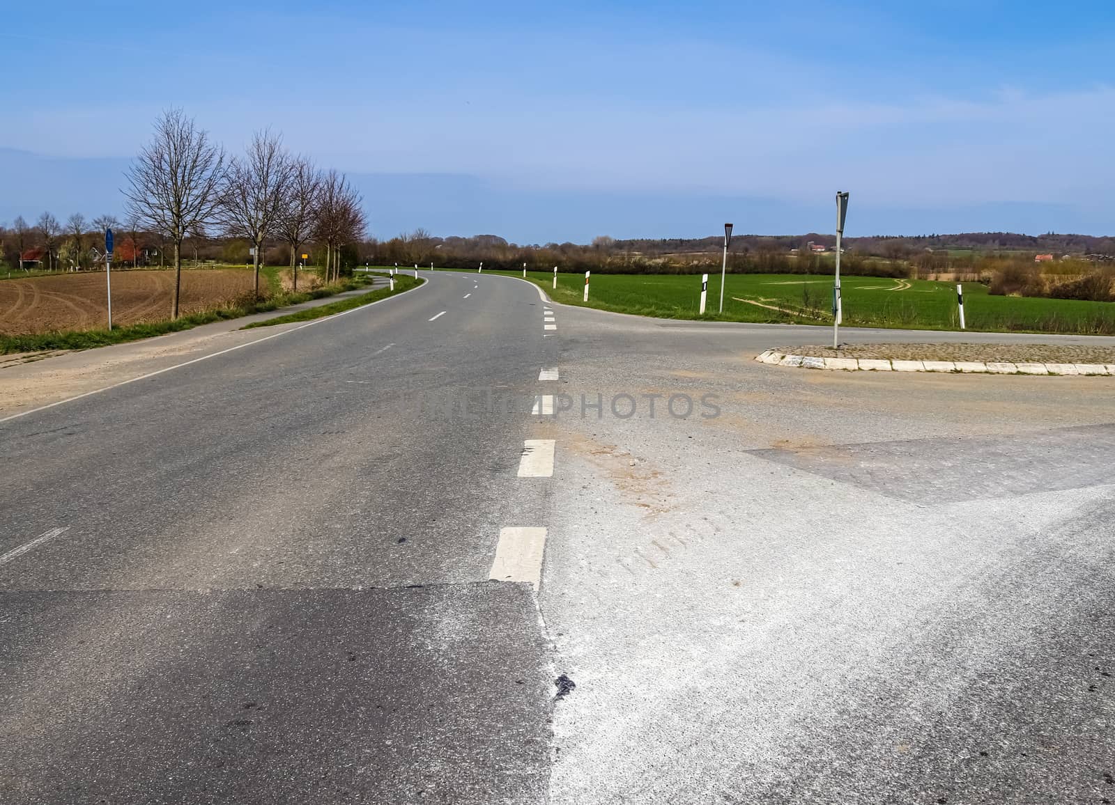 Beautiful view on countryside roads with fields and trees in northern europe.