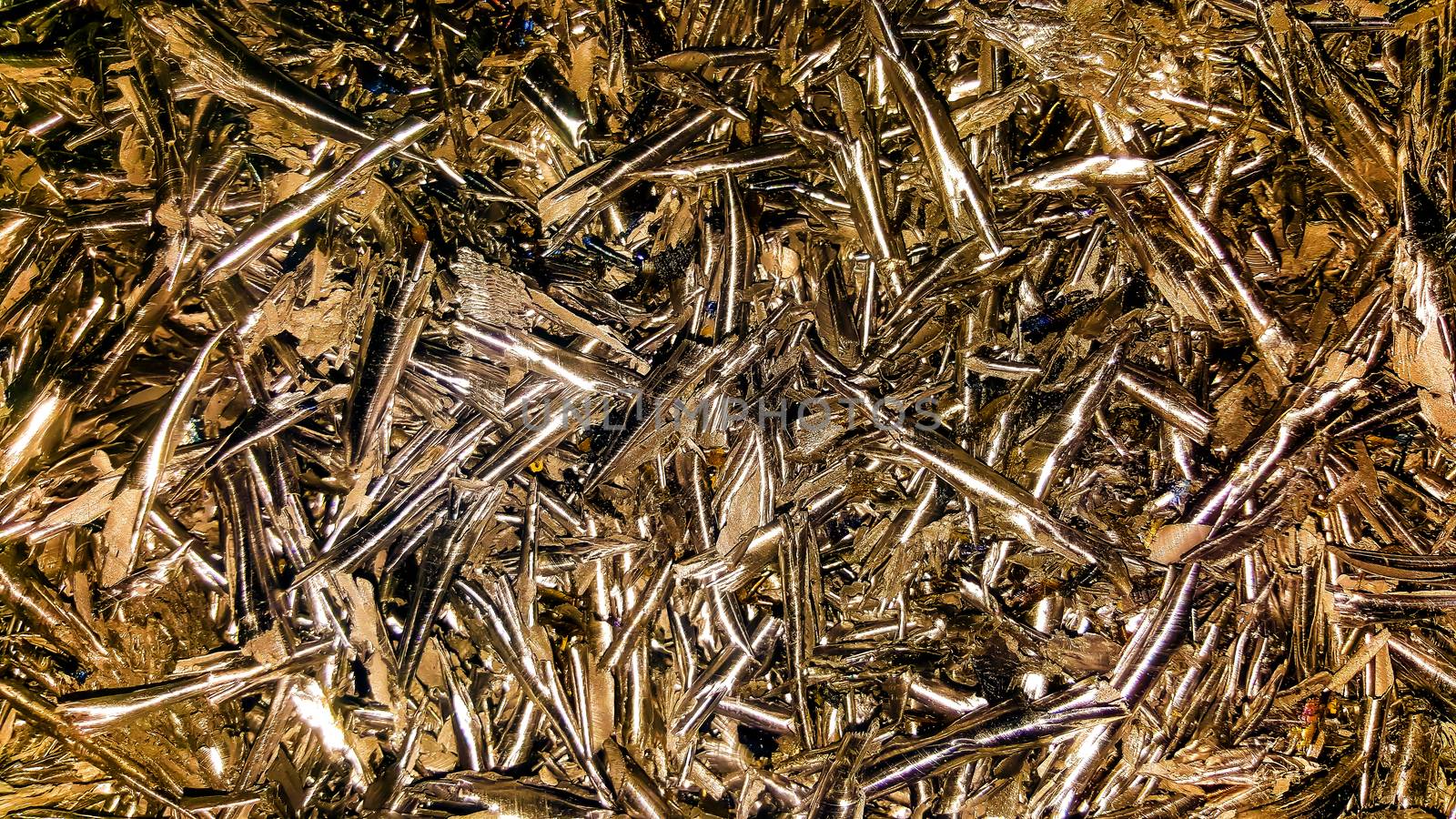 Processing of ferrous and non-ferrous metals in a factory or plant. Metal background. Abstract color background of metal shavings.