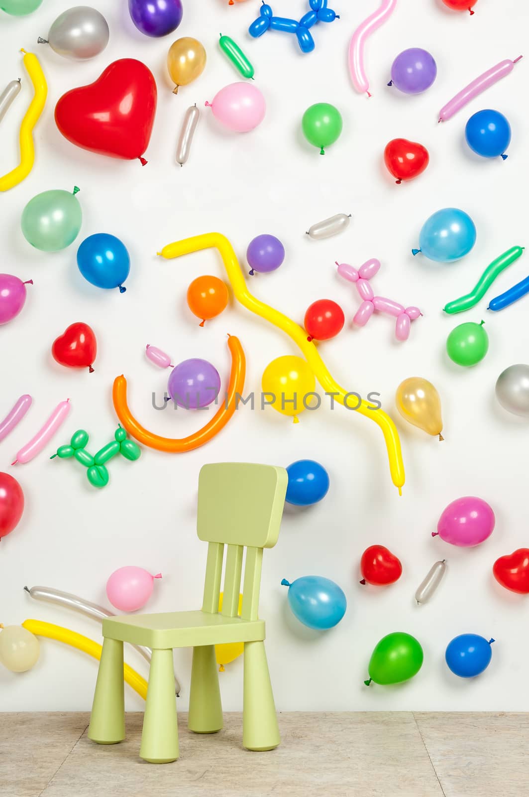 small highchair on a background with balloons