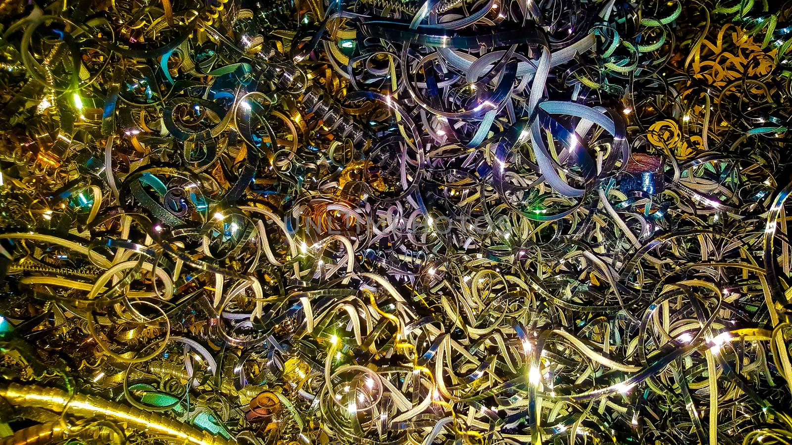 Abstract color background of metal shavings. Processing of ferrous and non-ferrous metals in a factory or plant. Metal background. Colored shavings. Wallpaper or screensaver of colored metallic chips