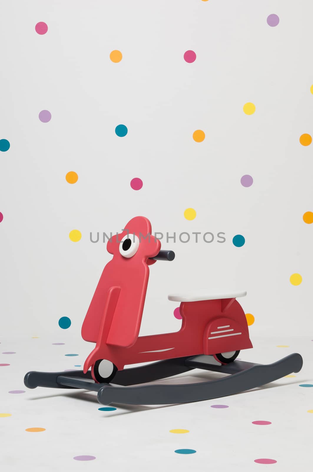 homemade red children's toy motorcycle on a white background