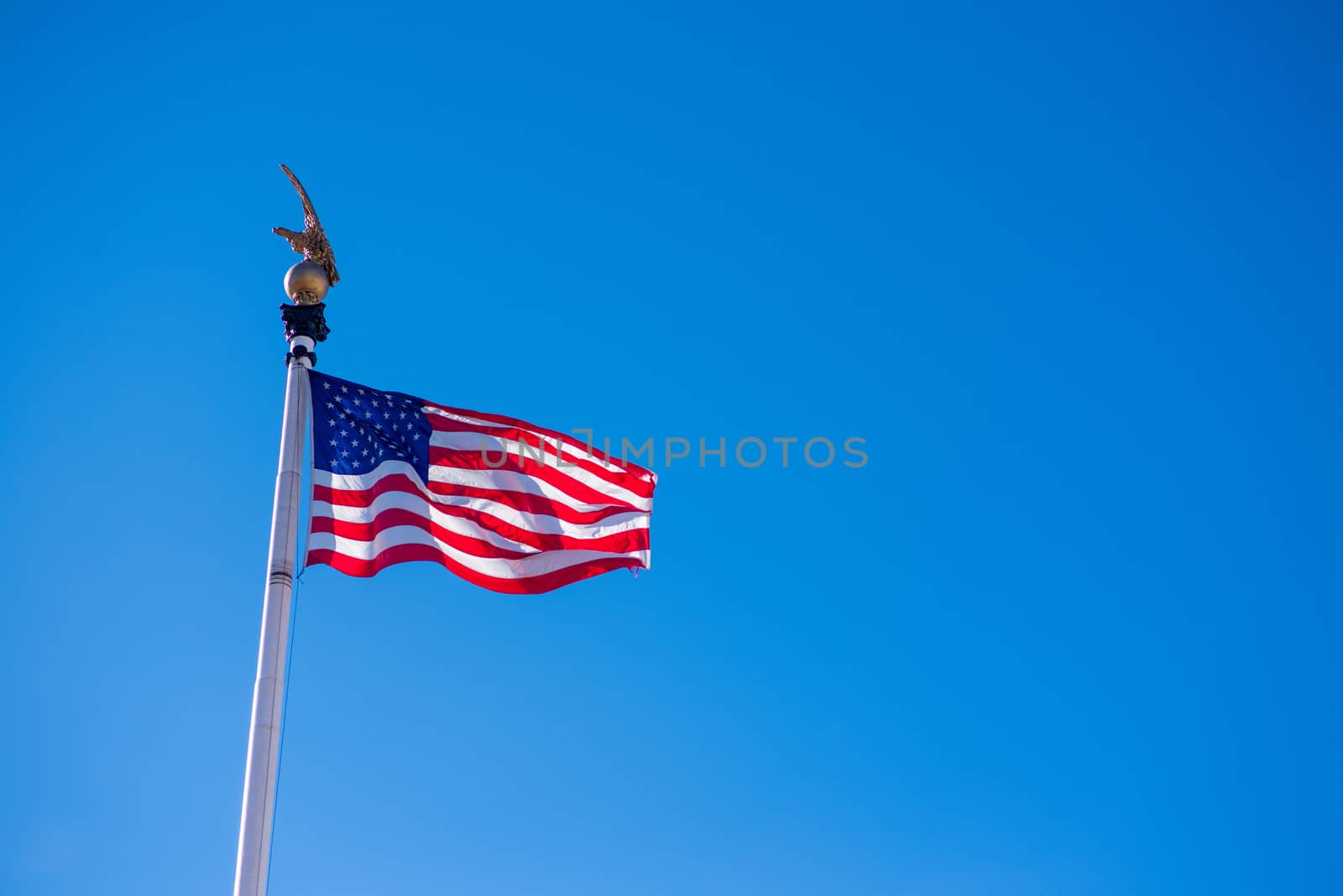 Star Spangled Banner on flag pole waving in the wind