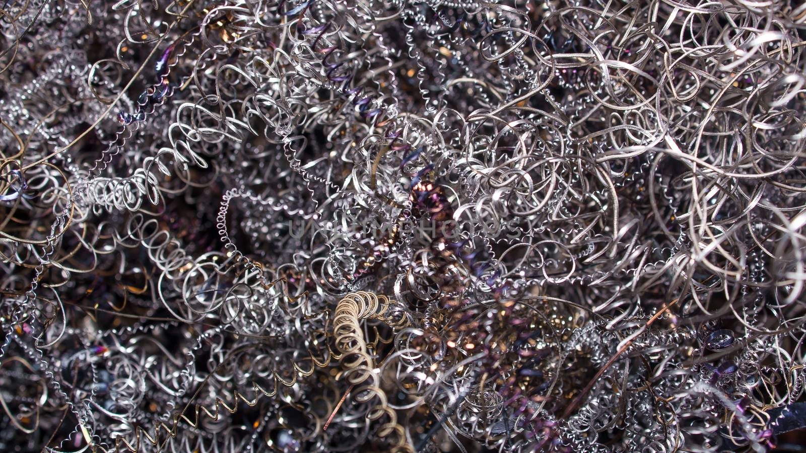 Colored shavings. Wallpaper or screensaver of colored metallic chips.Abstract color background of metal shavings. Processing of ferrous and non-ferrous metals in a factory or plant.Metal background. 