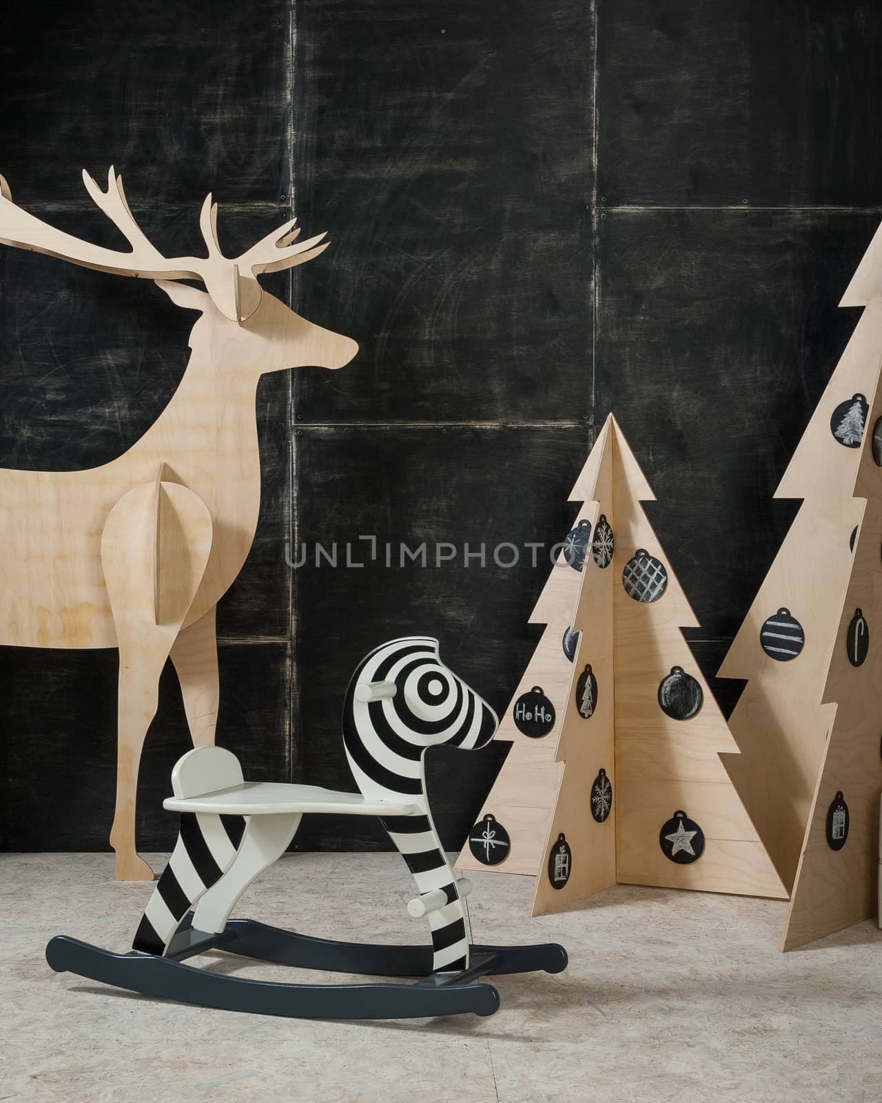 New Year's and Christmas decoration deer and fir plywood and wood on a dark background