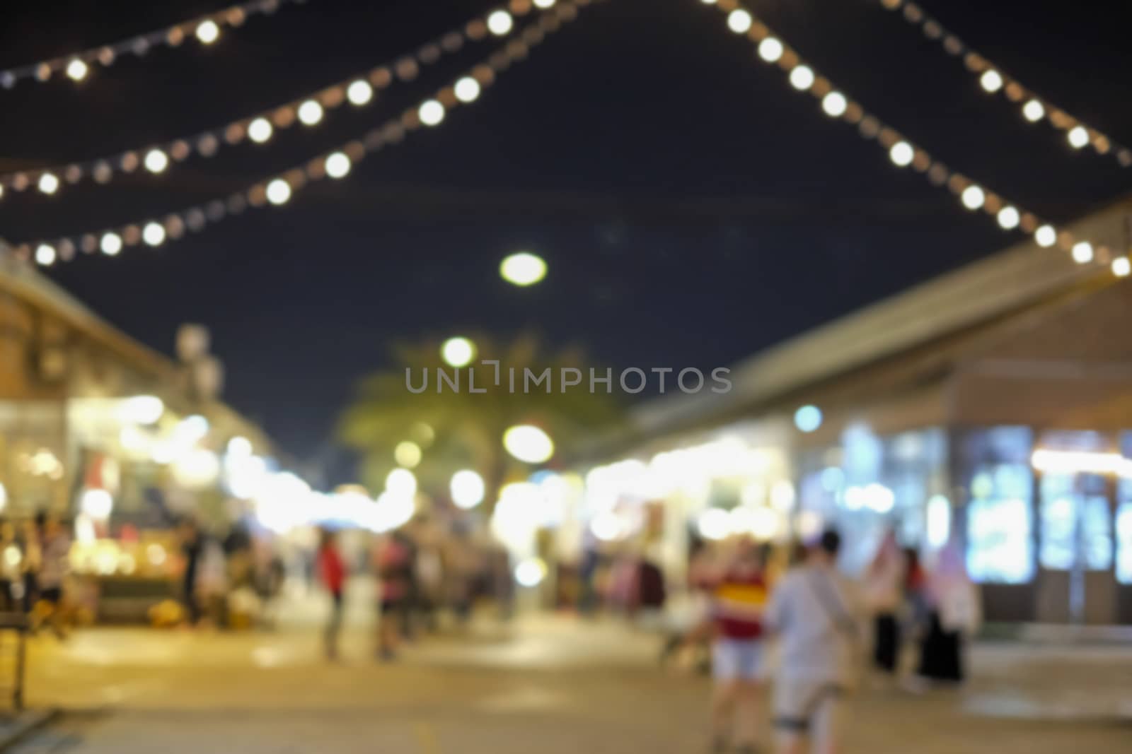 Abstract blurred background of people shopping at night festival