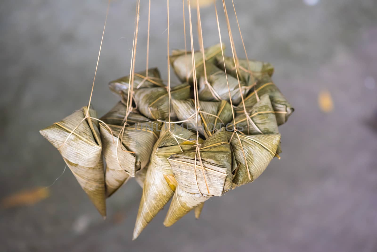 ZhongZi - traditional Chinese rice dish made of glutinous rice stuffed and wrapped in bamboo leaves hanging in the street