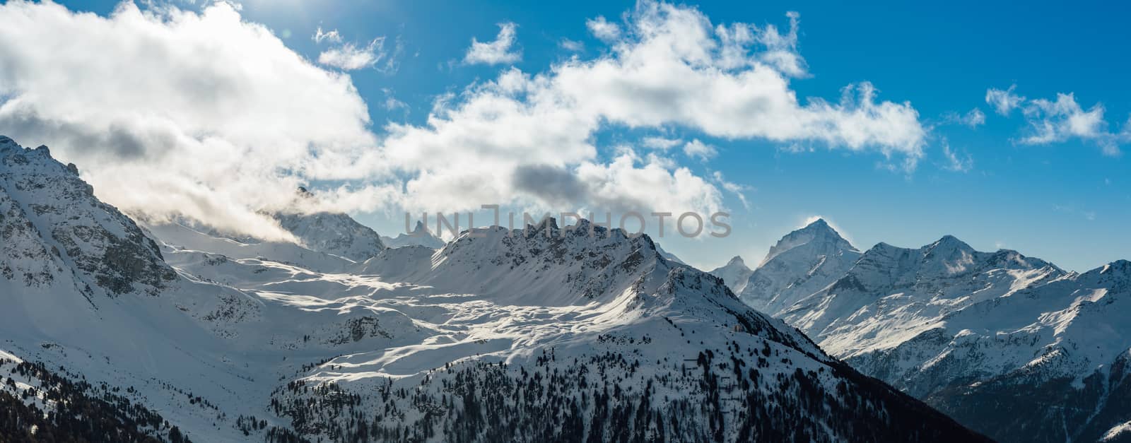 wide angle panoramic view of swiss alps during winter time.