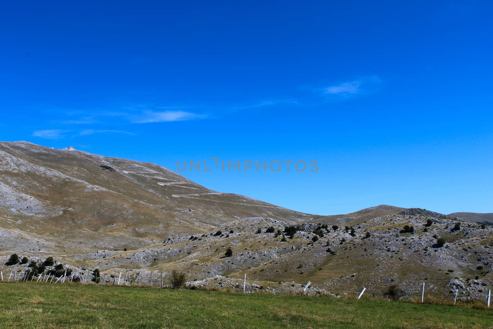 In the background, mountain desolation, with little vegetation. On the way to the mountain Bjelasnica. by mahirrov