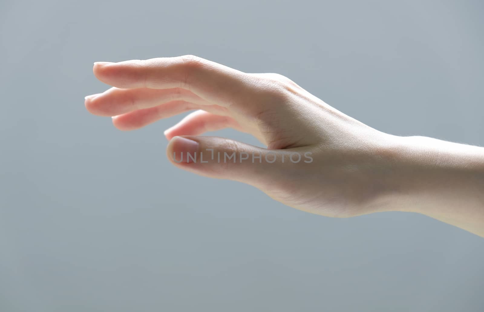 Young woman hand reaching out for touch something