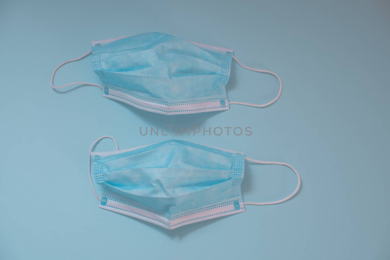 Surgical mask isolated against blue background shot from above by rushay