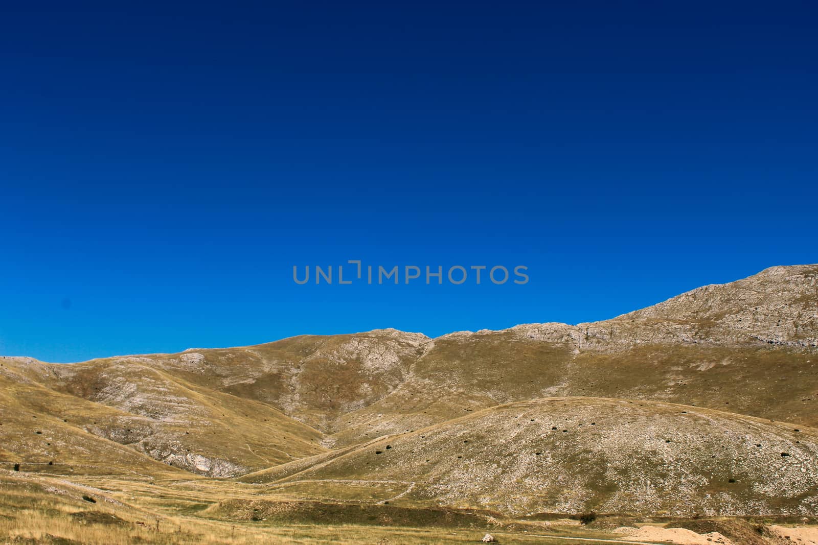 Mountain landscape, karst hill with a lot of stones and grass without other plants. Bjelasnica Mountain in autumn, Bosnia and Herzegovina. by mahirrov