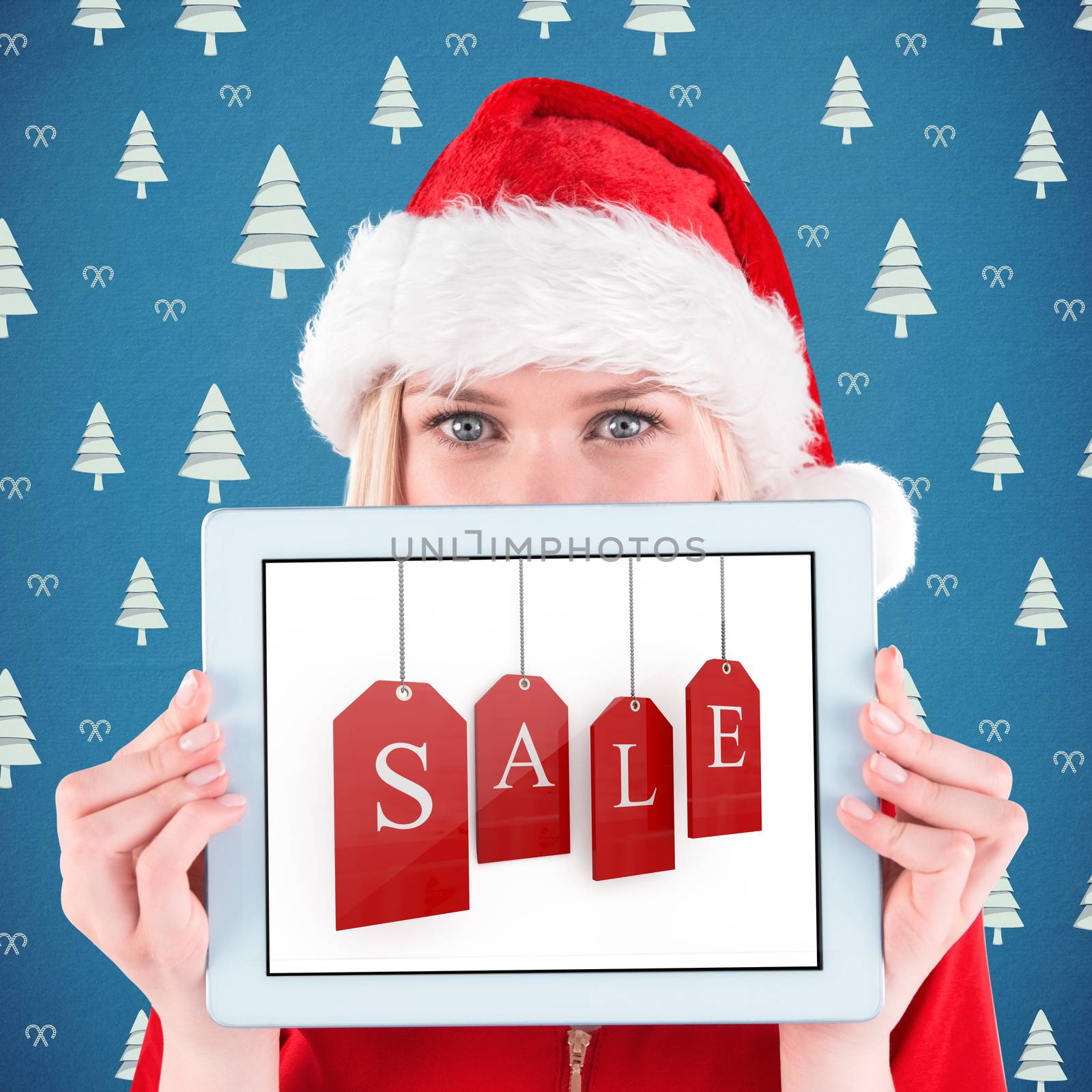 Composite image of festive blonde holding a tablet pc by Wavebreakmedia