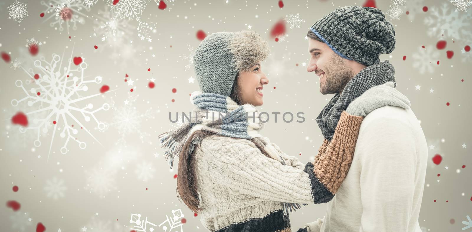 Young winter couple against snowflake pattern