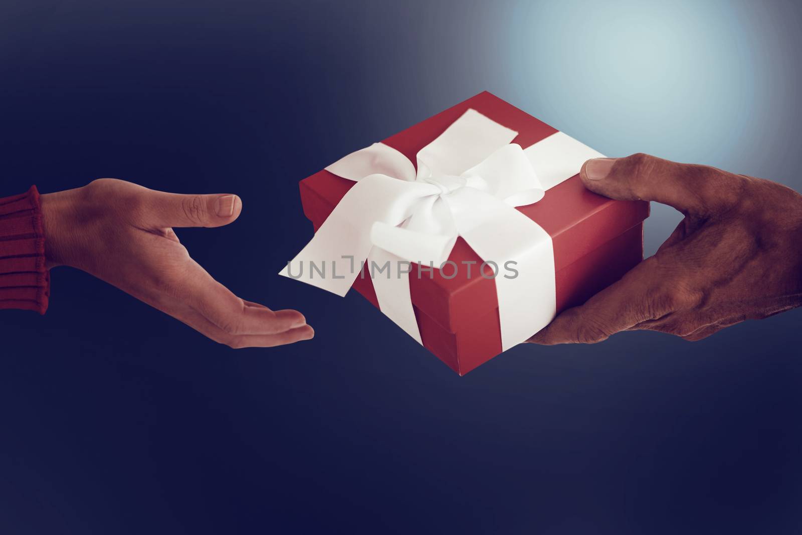 Couple holding gift on dark background