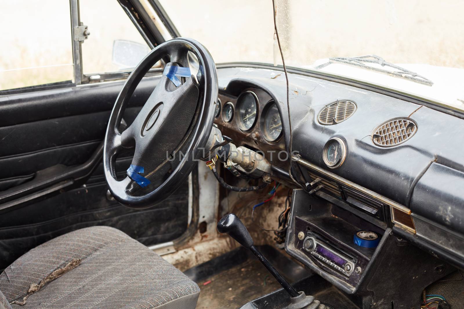 The very damaged interior of an old car from the 1980s by ArturNyk