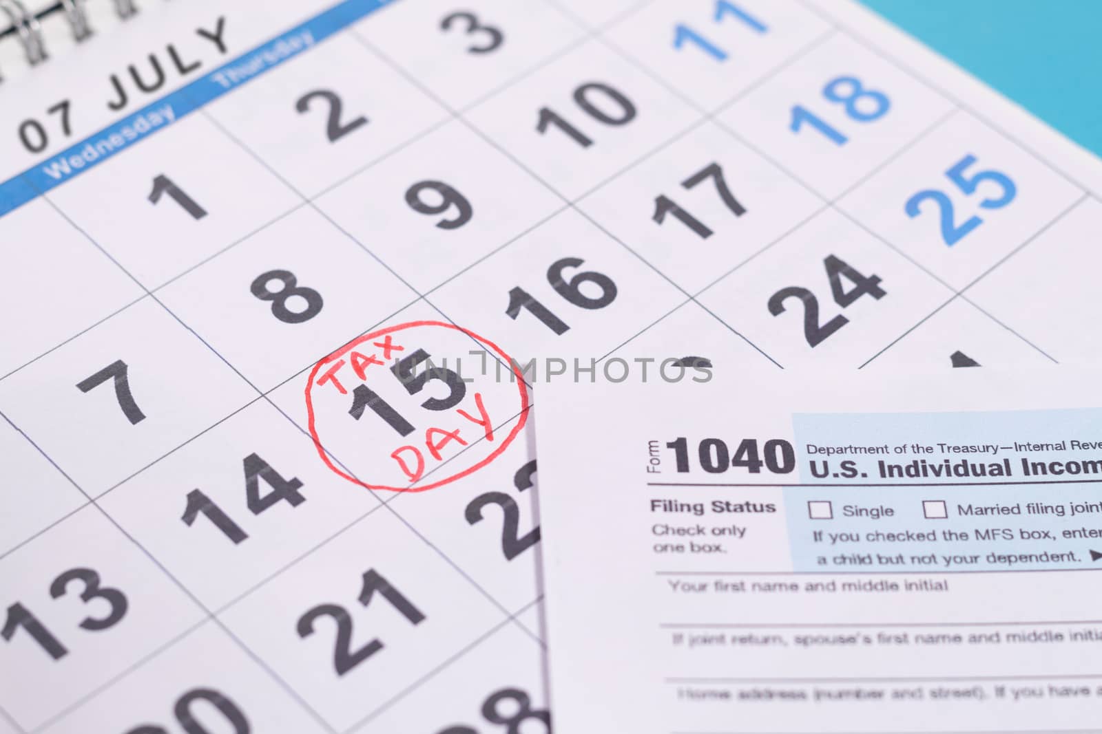 July 15th marked as tax day on calendar with Tax from - Concept of file tax form before deadline july 15th by lakshmiprasad.maski@gmai.com