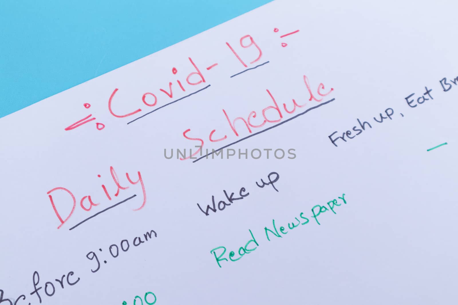Concept of planning daily schedule during covid-19 or coronavirus lockdown or home quarantine - Close up of Covid-19 daily schedule planner written on white paper by lakshmiprasad.maski@gmai.com