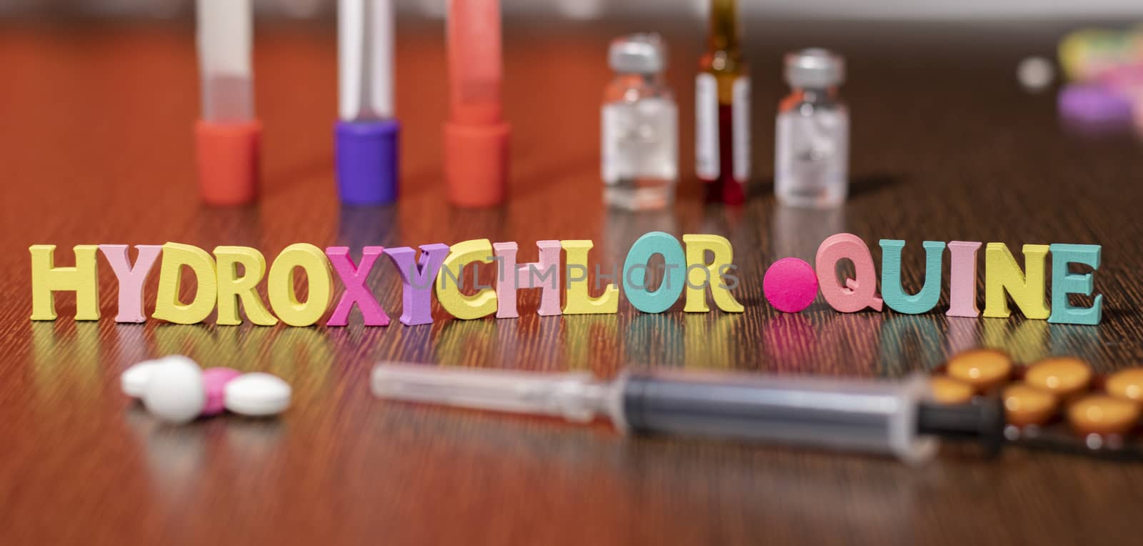 hydroxychloroquine or HCQ drug in colourful letters on table used for malaria