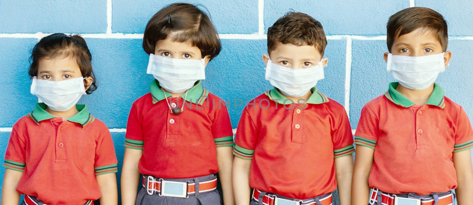 School preteen kids with protection face mask against new coronavirus, covid -19, nCov 2019 or sars cov 2 virus at school - children wore medical mask due to coronavirus outbreak. by lakshmiprasad.maski@gmai.com