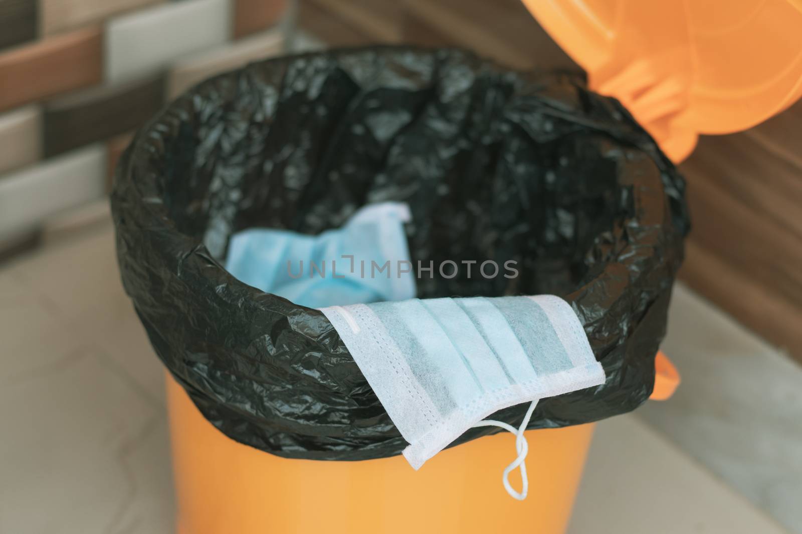 Covid-19, 2019-nCov or Coronavirus advice to discard or dispose the medical face mask to closed bin or trash can properly after usage - concept showing to do hygiene practice. by lakshmiprasad.maski@gmai.com