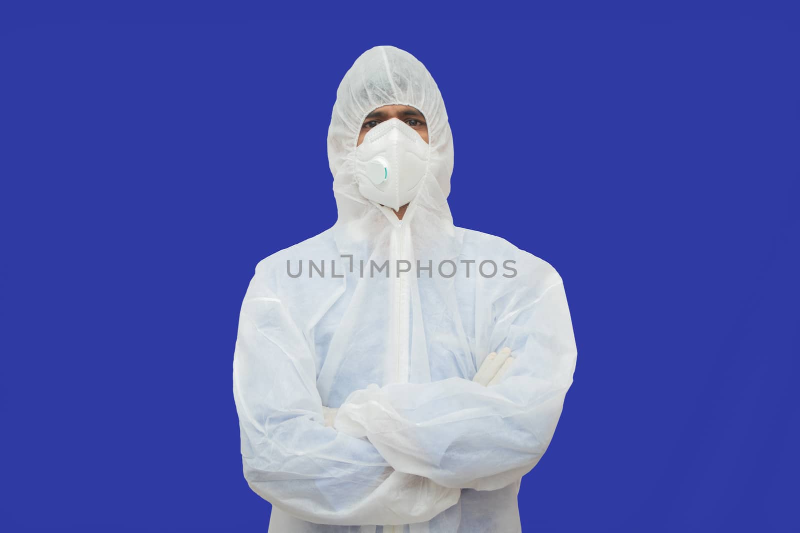 Confident epidemiologist in hazmat suit with medical face mask - Concept to fight covid-19 or coronavirus outbreak by controlling virus spread