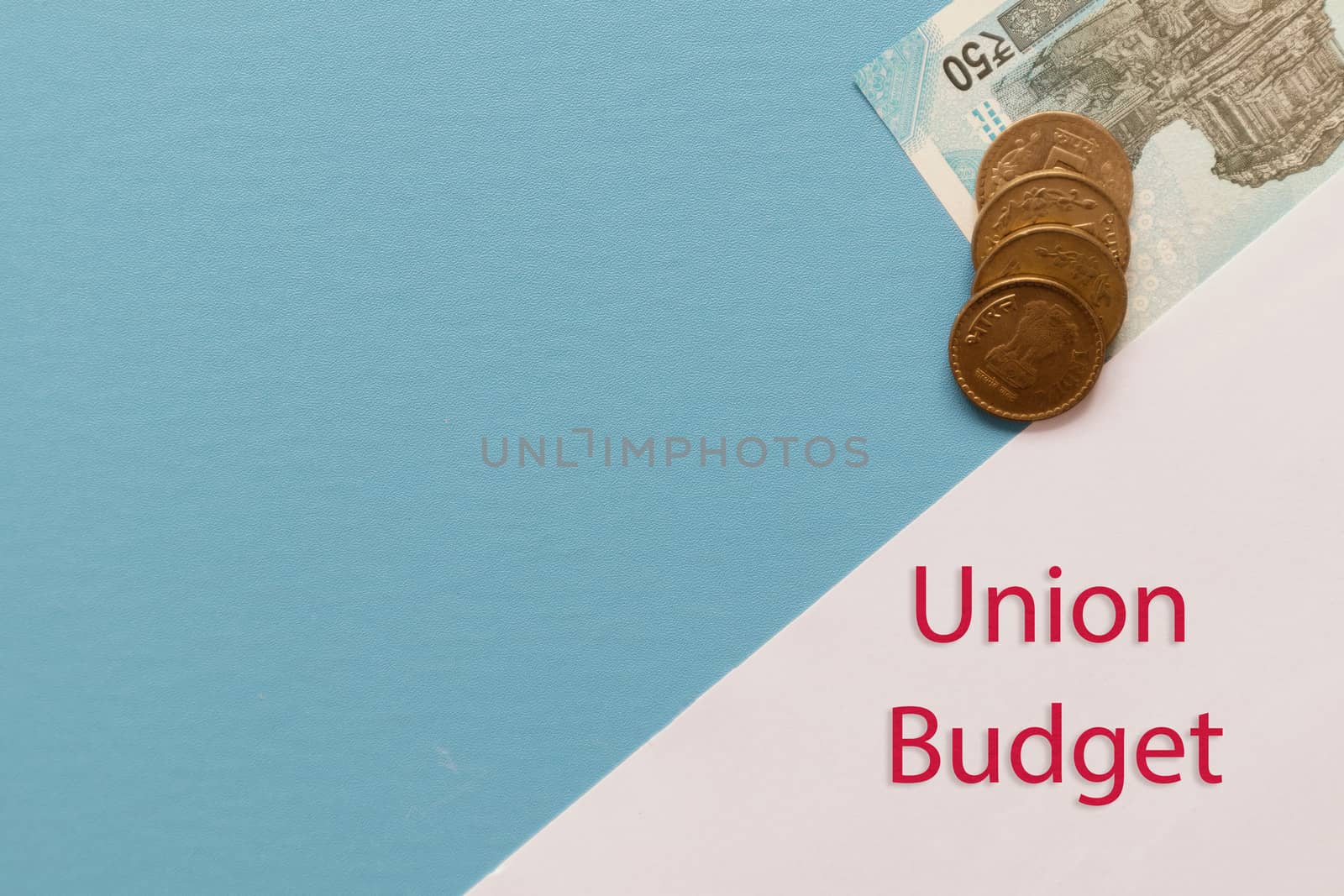 Concept of Indian Union budget with Indian currency notes, coins with copy space on blue background