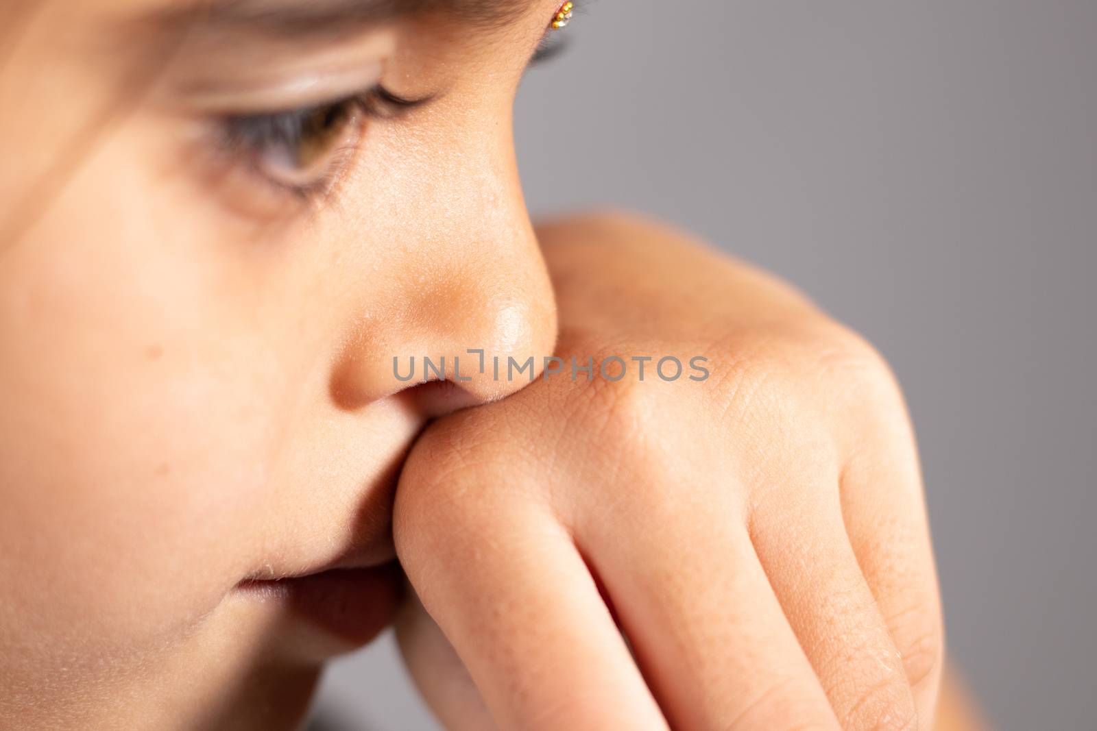 Extreme close up of child touch's her Nose - concept showing to prevent and Avoid touching your Nose. Protect from COVID-19 or coronavirus spreading or outbreak - Don t Touch Your Nose