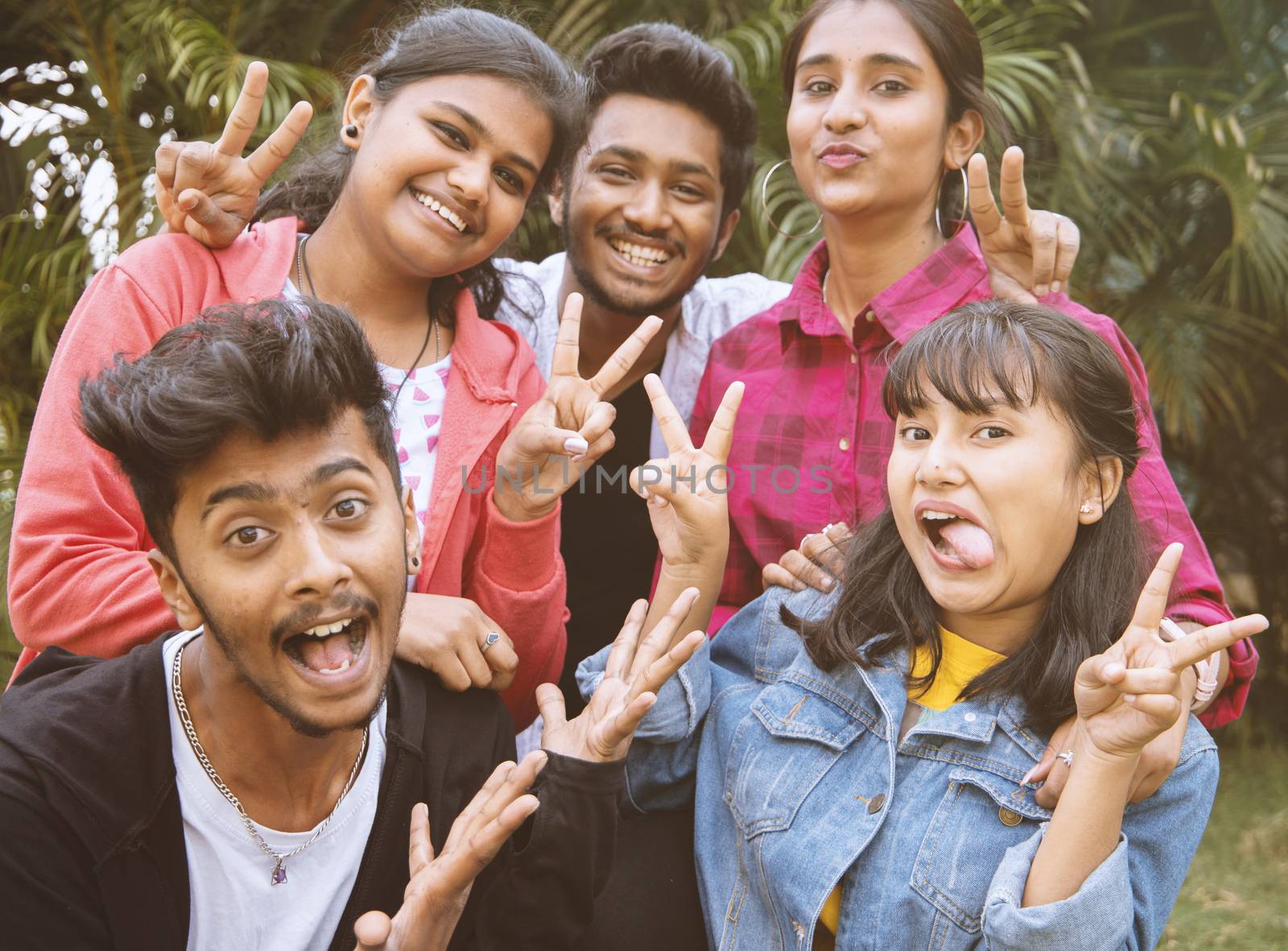 Young teenage friends taking selfie with funny faces - Concept of youth happy friendship having fun together - Millennials of selfie generation. by lakshmiprasad.maski@gmai.com