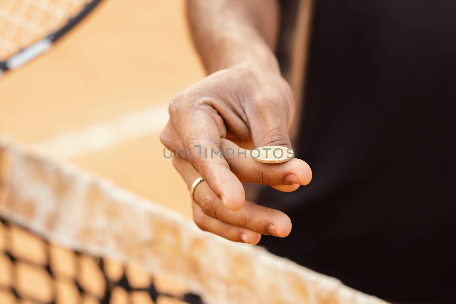 Close up of referee hands flipping a coin before starting the game or match. by lakshmiprasad.maski@gmai.com