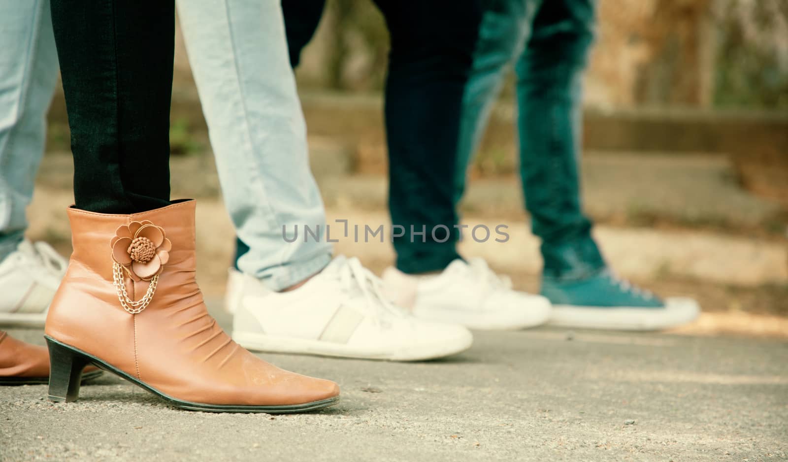 Close up of legs, Group of friends hanging out together - friendship, travel, tourism, summer vacation and people concept - closeup of trendy fashioned millennials walking in city