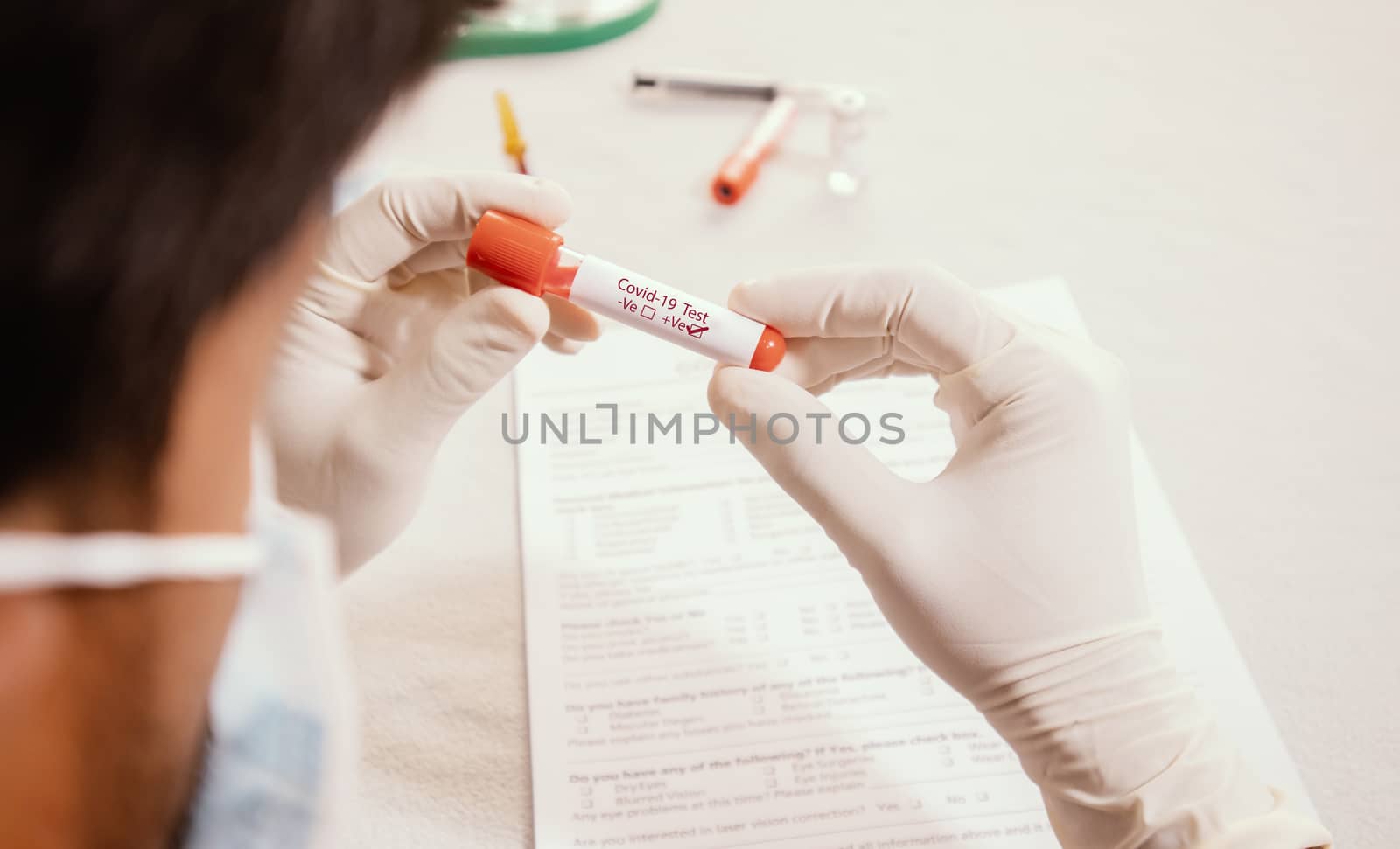 Doctor holding test tube with Positive Coronavirus or Covid-19 test blood sample - Concept of 2019-nCoV pandemic, Novel Chinese Coronavirus, Wuhan Coronavirus blood analysis.