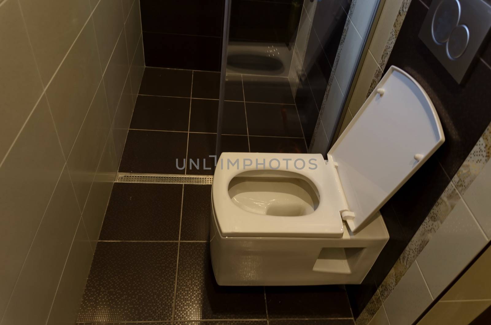 Modern interior toilet with white ceramic toilet bowl in a renovated home, Sofia, Bulgaria
