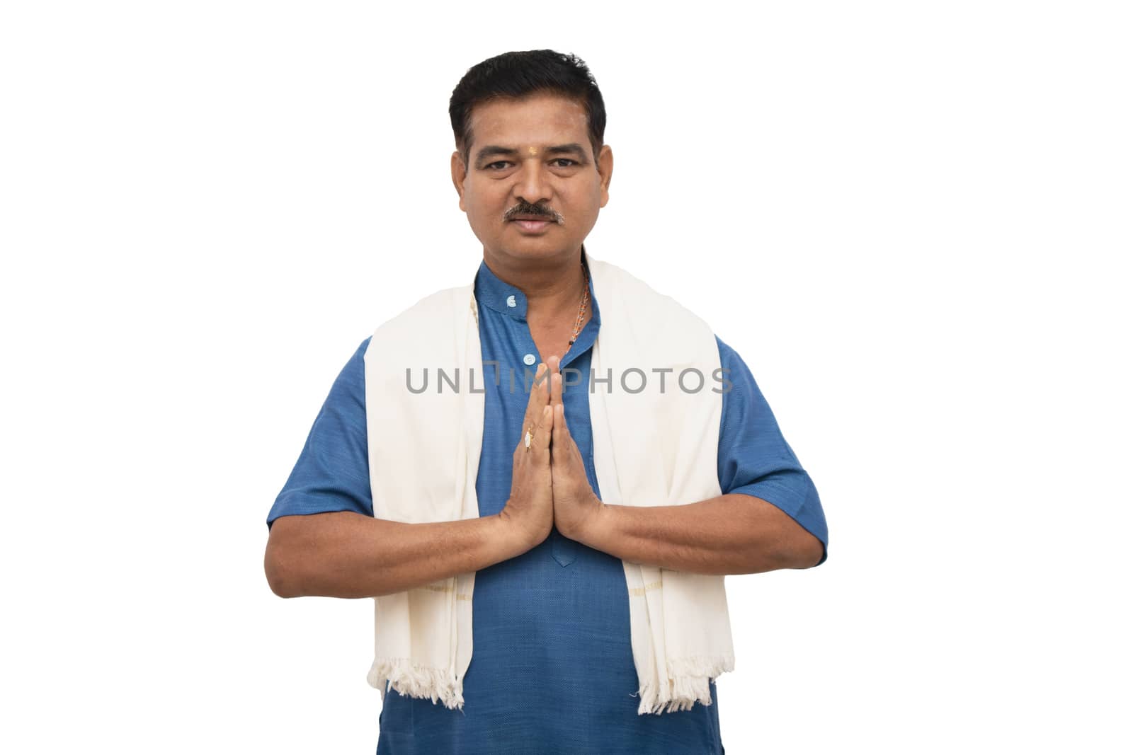 Handsome Indian man in traditional ware showing namaste gesture on isolated background