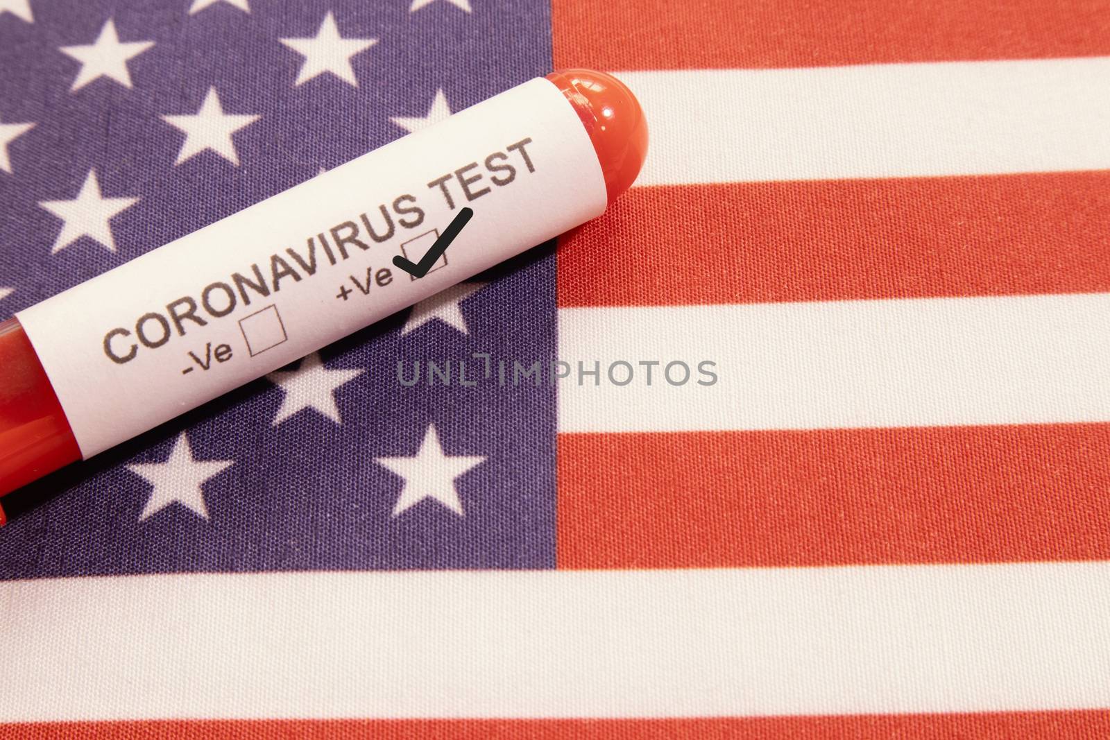 Coronavirus positive test on blood collection tubes on US flag - concept of virus found in USA
