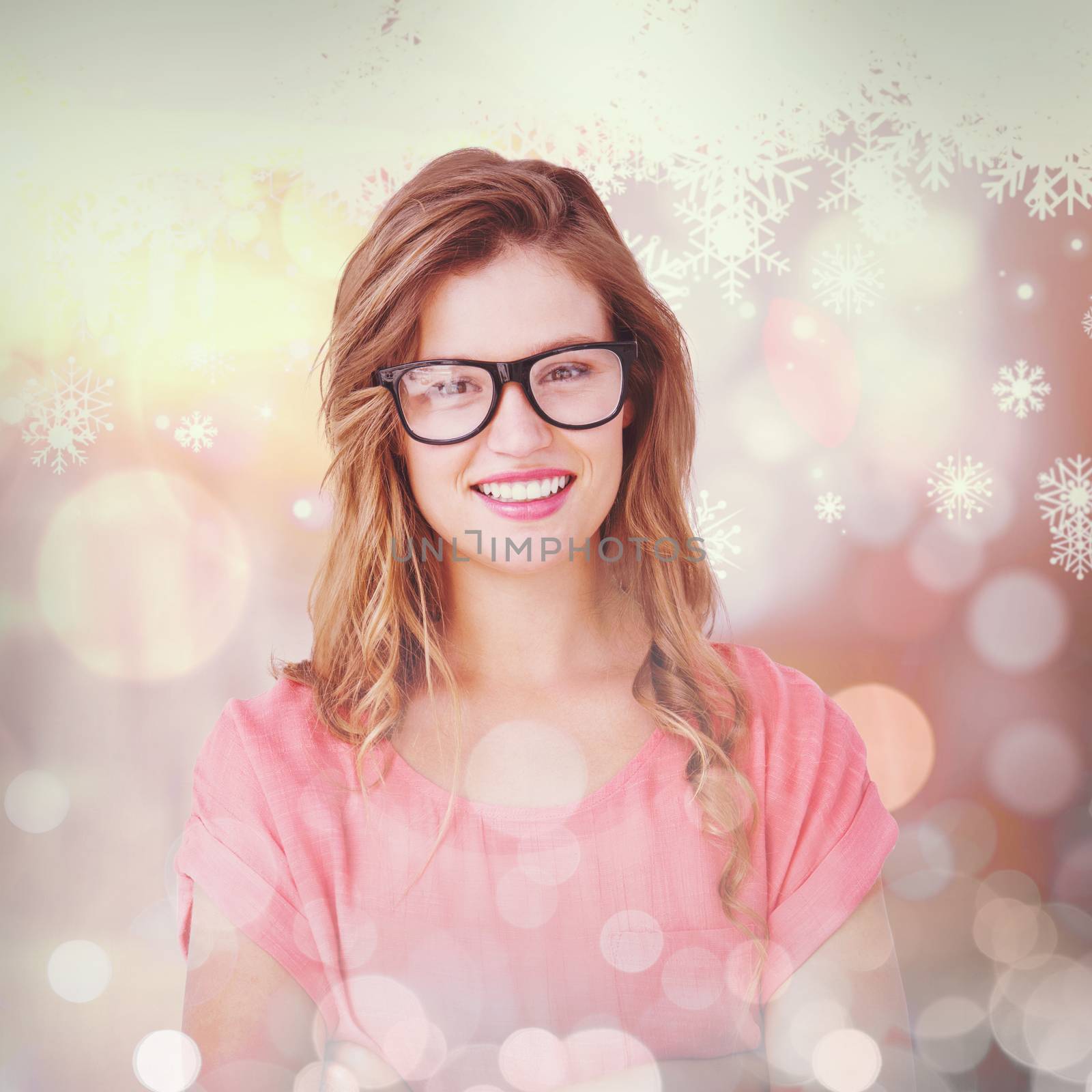 Pretty geeky hipster smiling at camera  against snowflake pattern