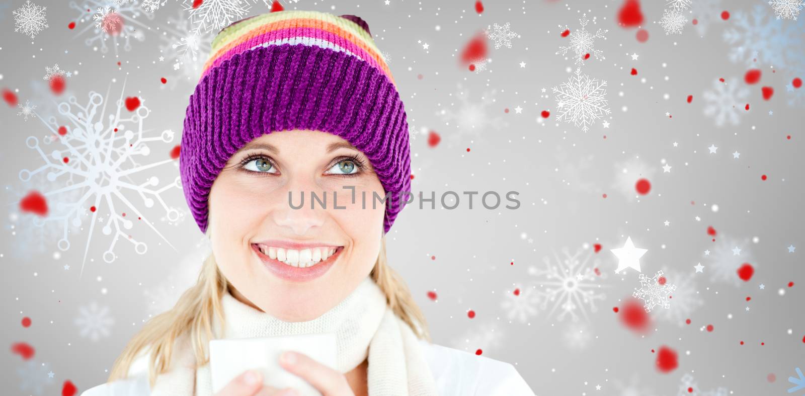 Smiling woman with a colorful hat and a cup in her hands against snowflake pattern