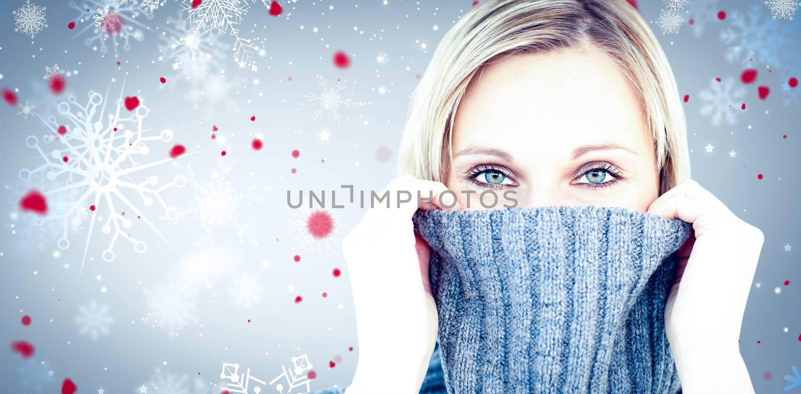 Delighted woman wearing a poloneck-sweater smiling at the camera against snowflake pattern