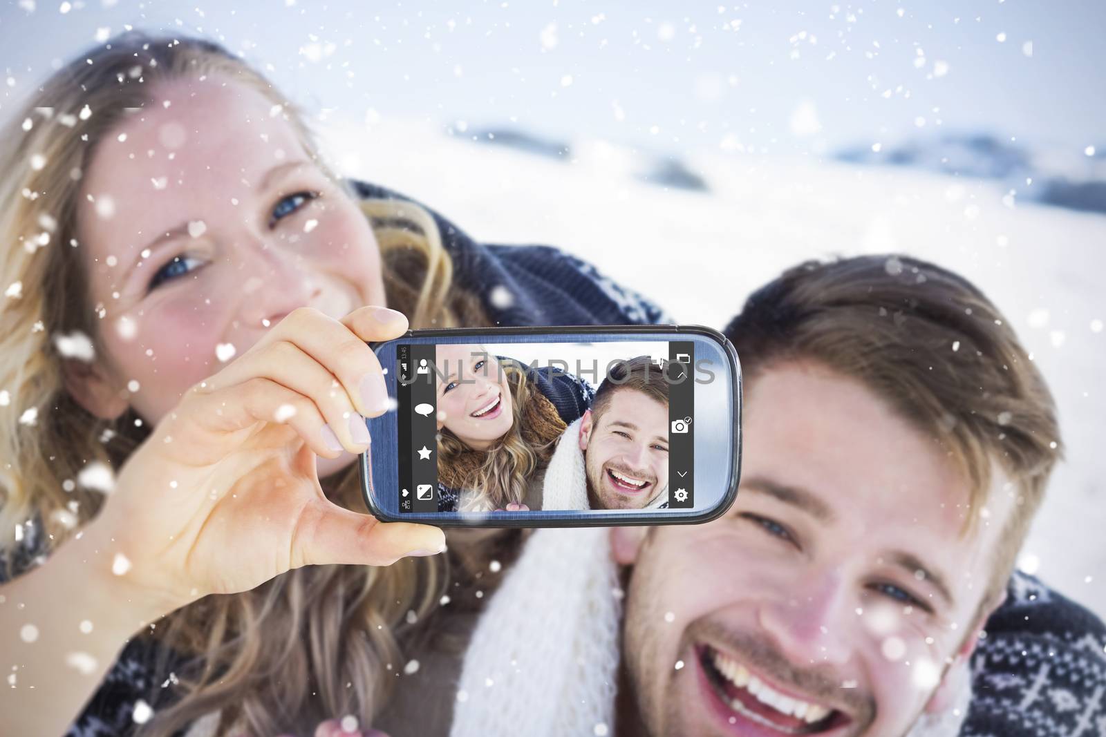 Composite image of hand holding smartphone showing by Wavebreakmedia