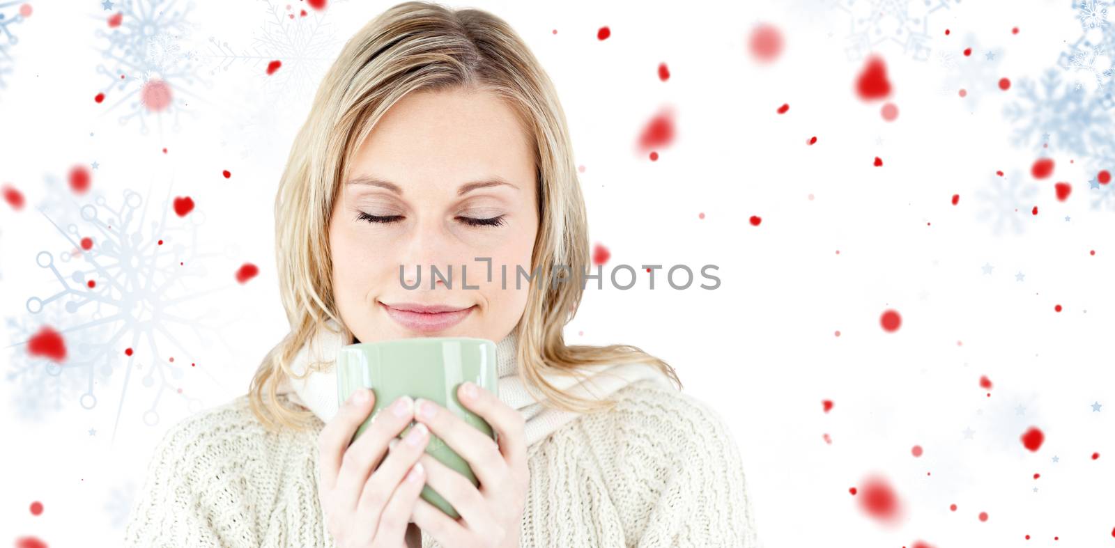 Happy woman enjoying a hot coffee standing  against snowflake pattern
