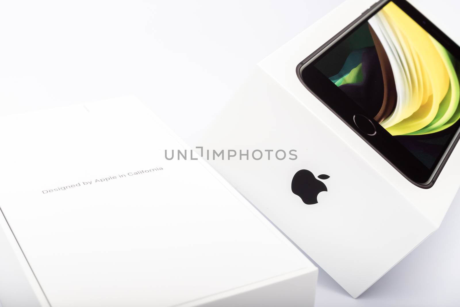 Paris, France - May 14, 2020: packaging of the new black iPhone SE 2020 from the multinational company Apple during the days of its studio release on a white background