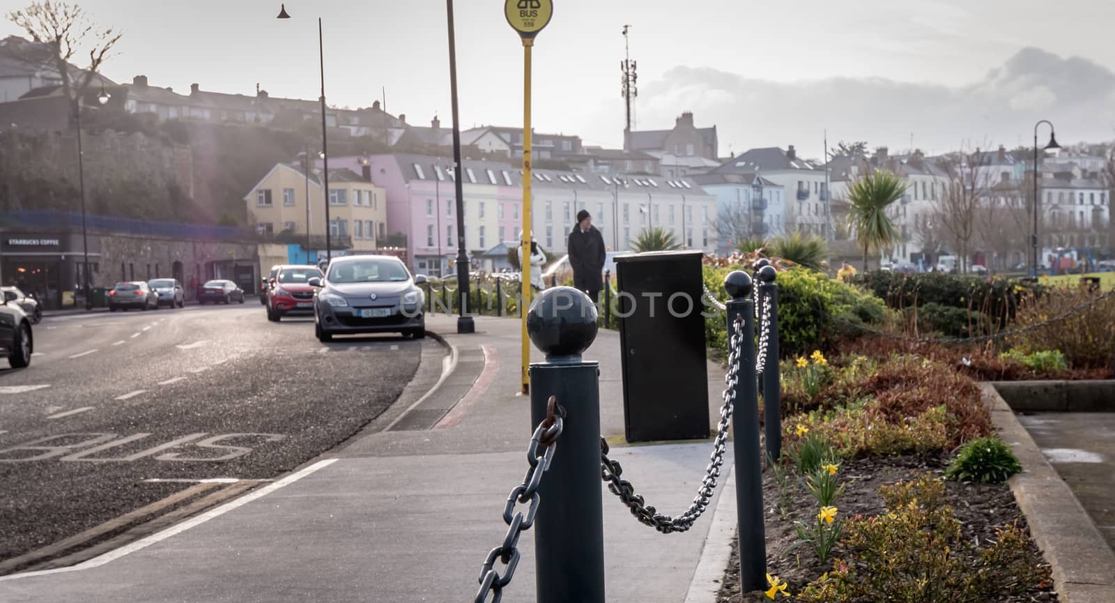 Howth, Ireland - February 15, 2019: people walking in the typical city center of a small fishing port near Dublin on a winter day