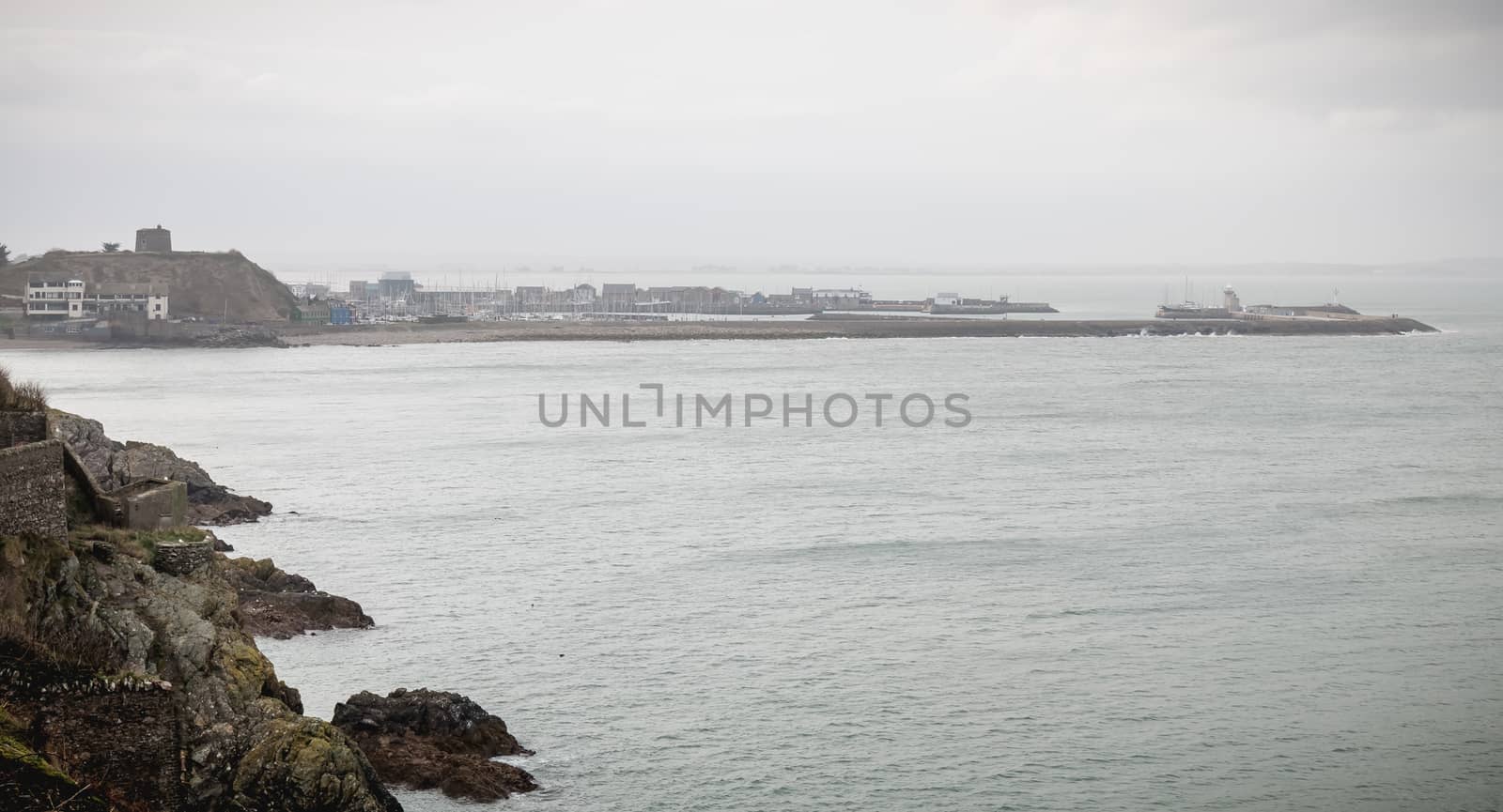Howth, Ireland - February 15, 2019: Distant view of a small touristy fishing port near Dublin on a winter day