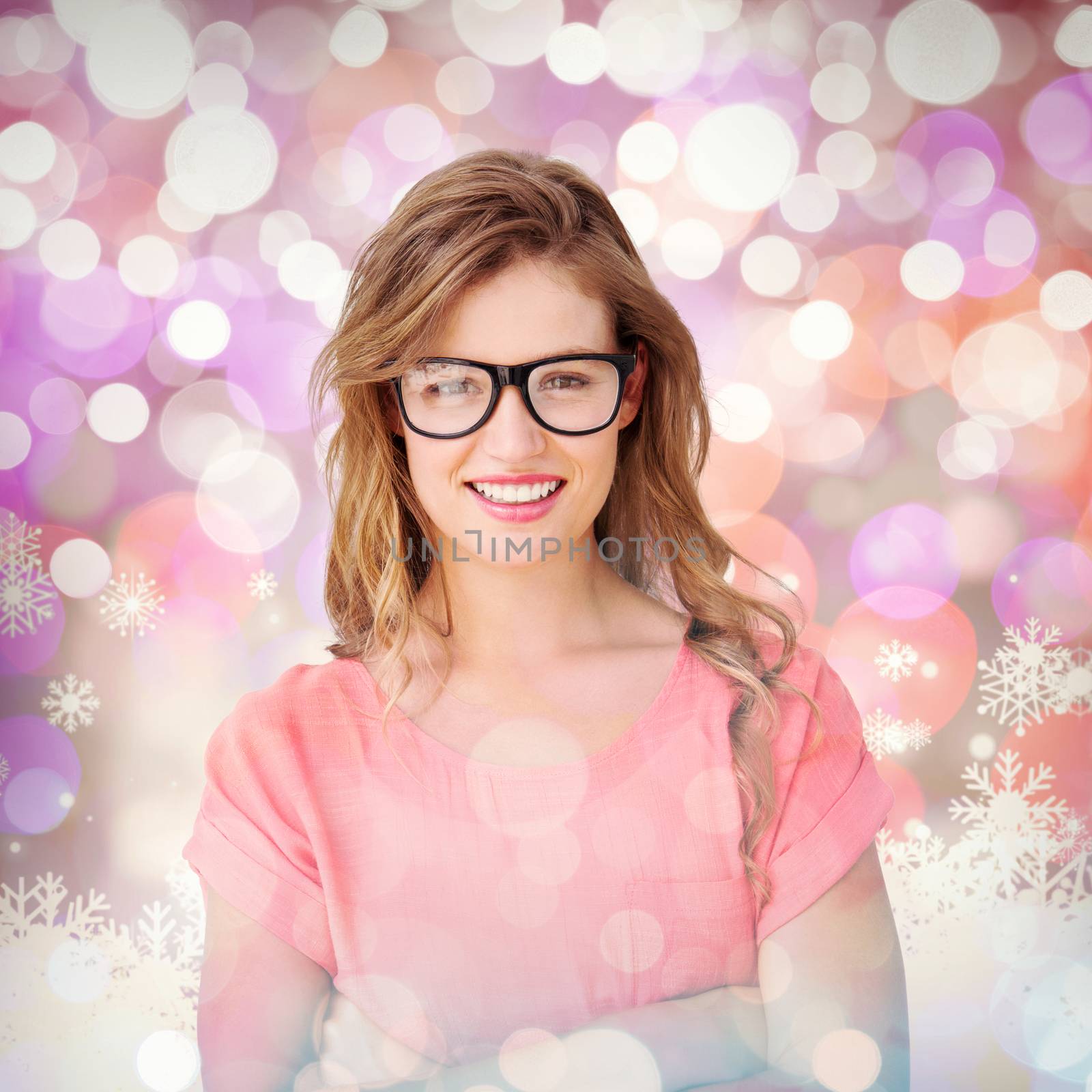 Pretty geeky hipster smiling at camera  against snowflake pattern